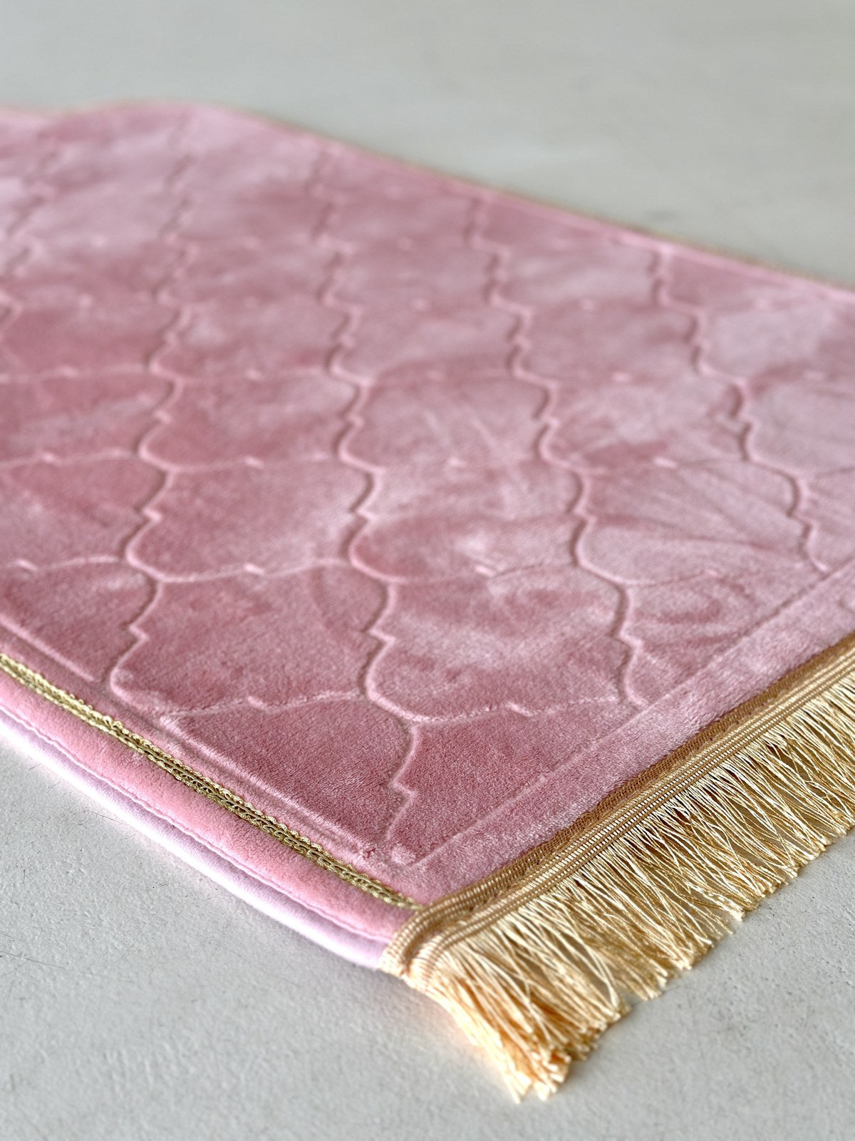 A plush prayer mat styled in a warm home setting