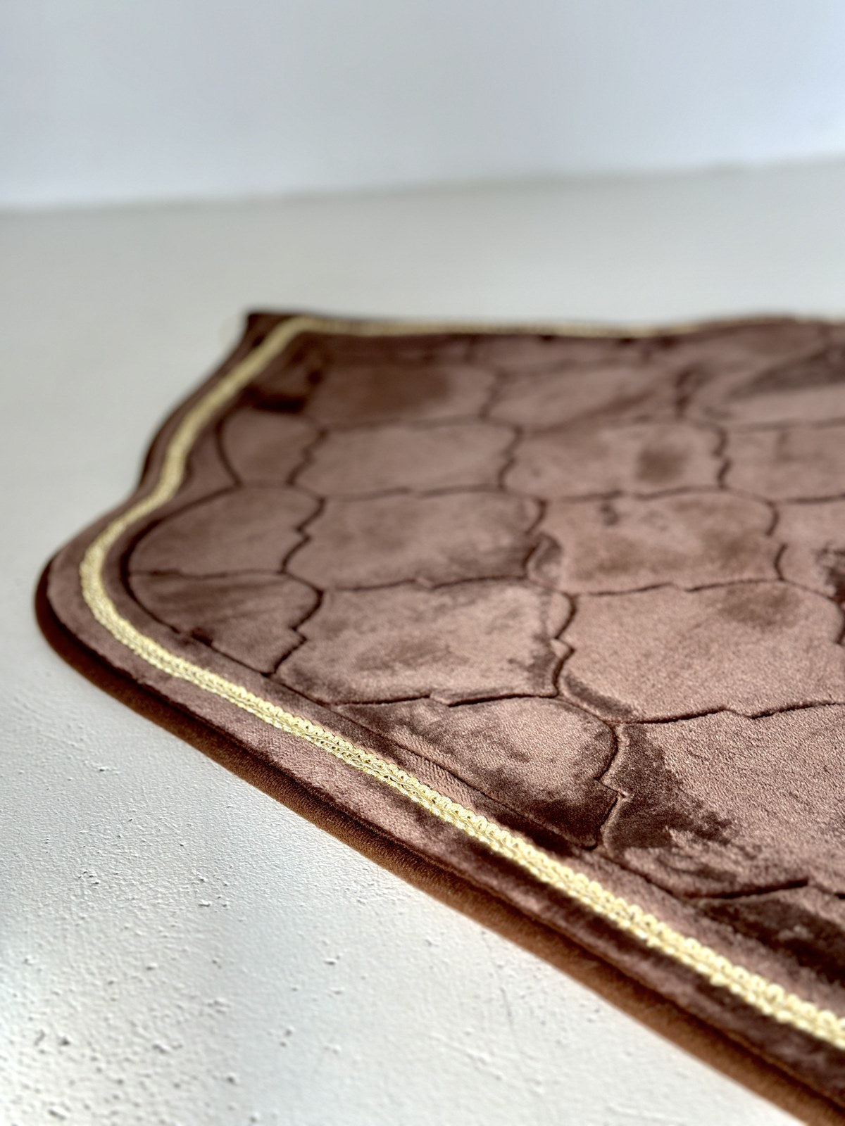 A close-up of the soft, plush texture of the prayer mat